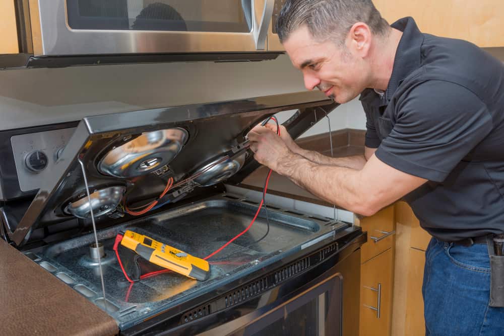 Professional Electrician Troubleshooting An Electric Stove Top Burner