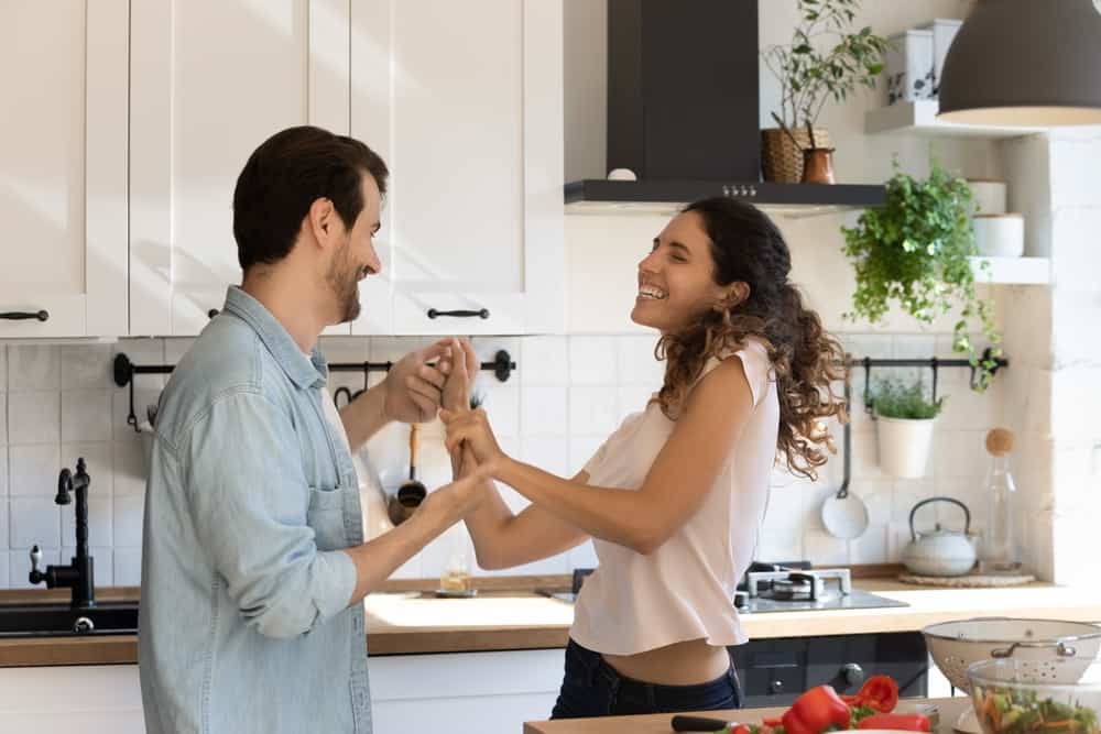 Couple In Love Hold Hands Dance In Kitchen Spend Carefree